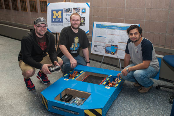 UM-Flint Engineering students pose with their tugger cart project. 