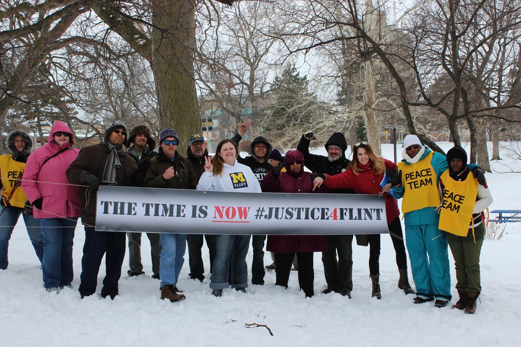 Tiffany Williams, center stands with #Justice4Flint Rally members in Wilson Park