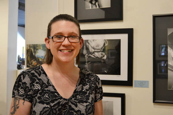 Breanna Kerrison stands with her photograph "Bits and Pieces"