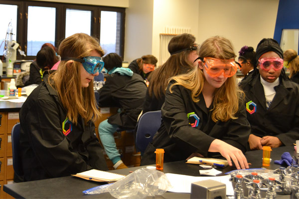 Curiosity Academy students conduct an experiment in the UM-Flint lab