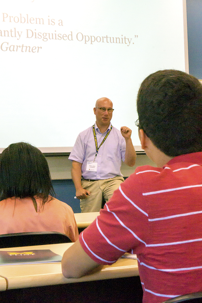 Professor Greg Laurence teaches summer camp students about the basics of Entrepreneurship. 