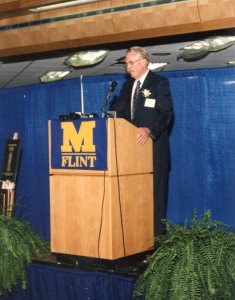 Dr. Kenneth West, professor in UM-Flint History Department, speaks at library dedication ceremony, October 1994