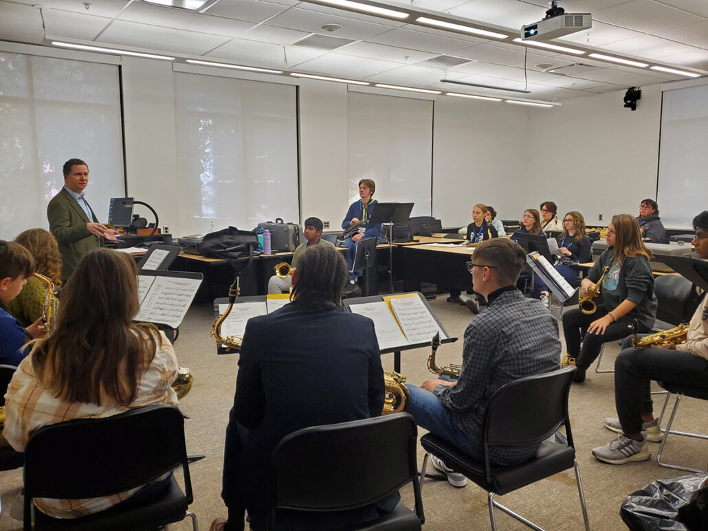 A UM-Flint Music instructor teaches high school saxophone students in a classroom