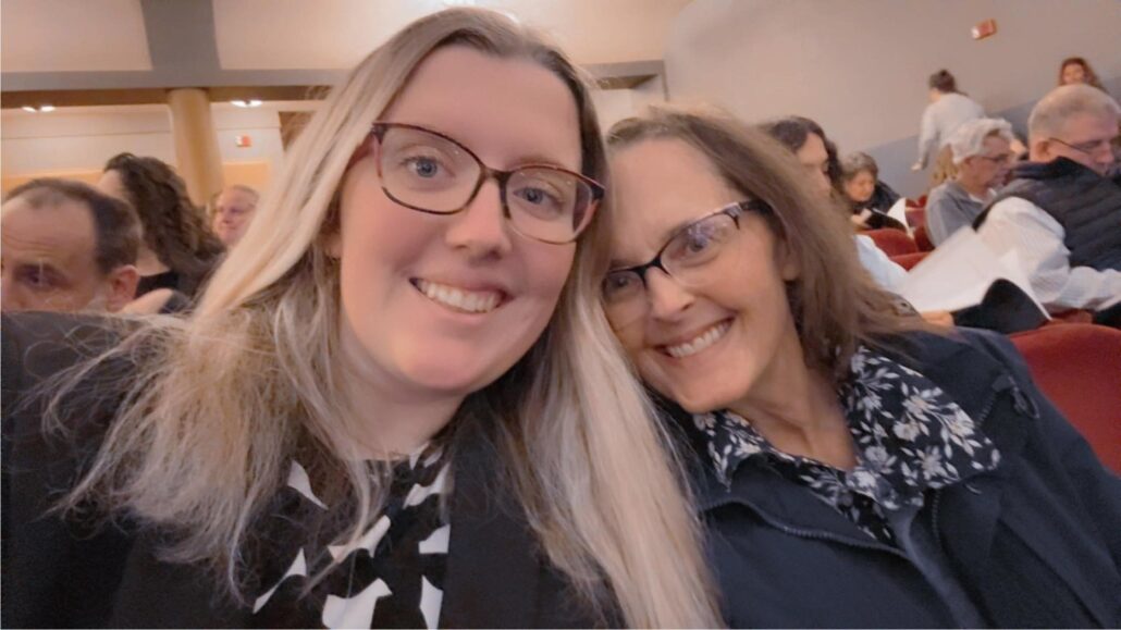 Two women smile at the camera