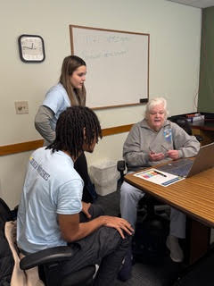 Photos of students, faculty, and seniors working together to help with technology including laptops, tablets, and mobile phones. 